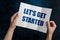 Man holding brochure with phrase LET`S GET STARTED on blue background, closeup