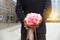 Man holding bunch of flower behind the back during valentine tim