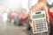 Man holding calculator for business finance on car showroom blurred bokeh background.for automotive automobile or transportation