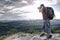 Man holding camera at eyes on mountain