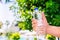 Man holding clear drinking water in a plastic bottle on summer blurred background