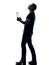 Man holding digital tablet looking up silhouette