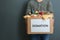 Man holding donation box with food on gray, closeup. Space for text