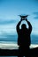 Man holding a drone for aerial photography. Silhouette against t