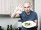 Man holding fingers in green olives