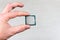 Man holding fingers mock up desktop processor 8th gen on grey background closeup