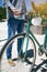 Man holding a fixed gear bicycle in the street while hanging a mask from the handlebars. Selective focus