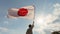 Man holding the flag of Japan against blue sky with sunrays