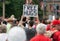 Man Holding Free Hugs Sign in Crowd