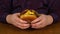 Man holding freshly prepared grilled beef burger