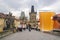 Man holding glass of light beer with view of Charles bridge in Prague