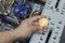 Man holding golden bitcoin on the background of opened PC case