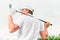 Man holding golf club behind his back