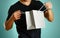 A man holding a gray gift bag. Close up. Isolated background