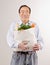 Man holding grocery bag full of fresh fruits