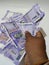 Man Holding Group of New Purple Color Indian Hundred Rupees Note Holding