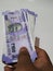 Man Holding Group of New Purple Color Indian Hundred Rupees Note Holding