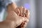 Man holding hand of his fiancee with engagement ring on finger, closeup