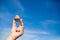 Man holding in hand rock on blue sky