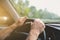 Man is holding hands on the car`s steering wheel. Raindrops on the windscreen. Guy is traveling in the bad weather. Dangerous