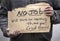 Man holding handwritten cardboard sign, No Job, Will Work, jobless, unemployed