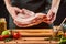 Man holding a huge piece of meat, preparing to cook barbeque beef ribs