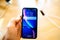 Man holding iphone Xr blue color liquid retina