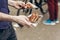 man holding juicy steak grilled meat in take to go box at street