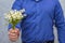 Man holding lilies of valley. Gift on March 8