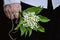 Man holding lily of valley flower bouquet