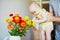 Man holding little baby girl and letting her touch flowers