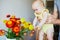 Man holding little baby girl and letting her touch flowers