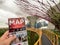 Man holding map of Singapore and background is the Aerial view of the Botanic Gardens, Bay Gardens at the South Bay