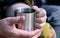 Man holding a metal cup closeup