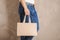 Man holding mock-up of paper shopping bag