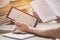 Man holding a modern ebook reader and book in library