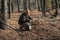 Man holding mushroom at the hand and shooting it at the smartphone while kneeling