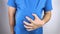 The man is holding onto his swollen belly. Bloating, flatulence, gas, malfunction of the gastrointestinal tract. Conceptual video