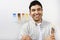 Man Holding Paintbrush In Front Of Color Samples