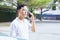 A man is holding a phone outside, wearing a face shield to protect against germs and viruses. Dust prevention and prevention of