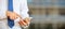 Man holding phone. Young businessman in business wear using a mobile, closeup view on smartphone, banner