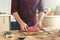 Man holding of piece of beef meat on a wooden table