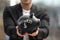 Man holding piggy bank with word BUSINESS against blurred background