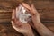 Man holding plastic bags with drugs on wooden background