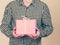 Man holding present pink gift box