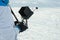 Man is holding a professional remote control from a quadrocopter against the background of a snow field.