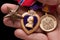 Man Holding Purple Heart, Bronze and National Defe