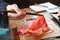 Man holding rare slice Wagyu A5 beef by chopsticks for boiling in Shabu hot pot