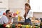 Man holding red box with ring making propose to his girlfriend in the kitchen