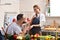 Man holding red box with ring making propose to his girlfriend in the kitchen